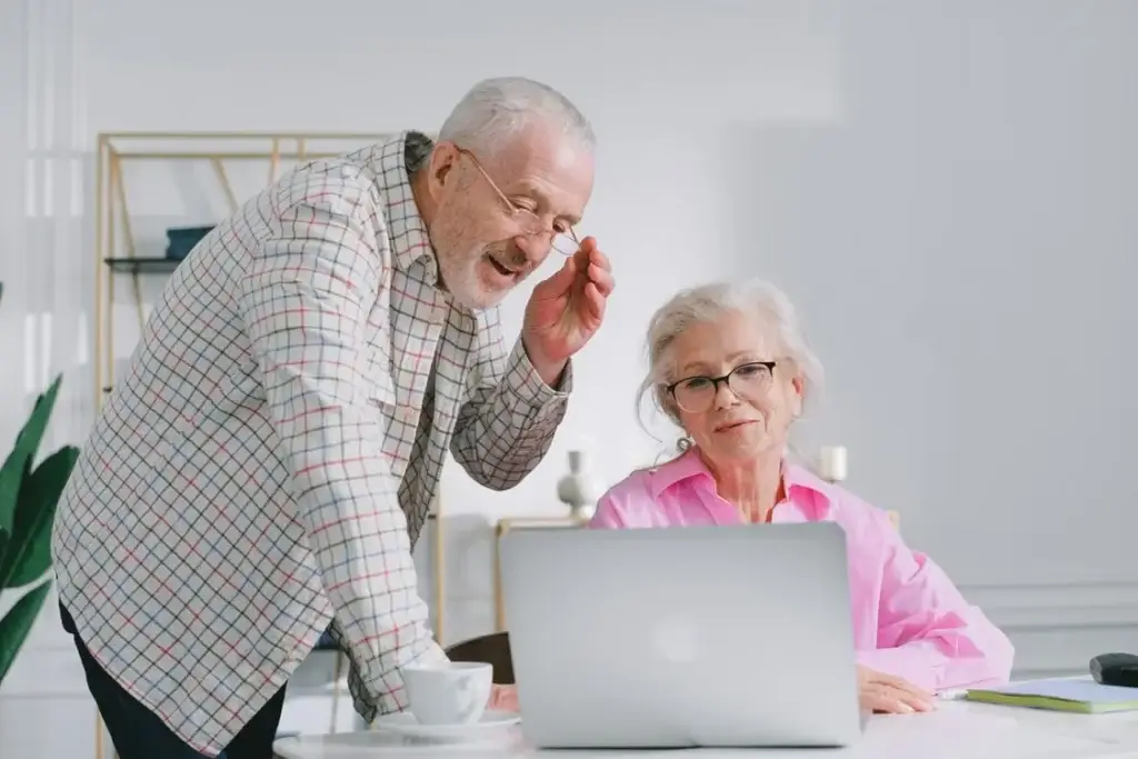 Senior couple reviewing information on a laptop together.